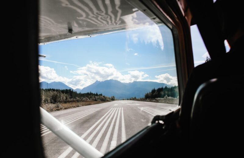 A mountain runway seen through the windscreen of a small aircraft