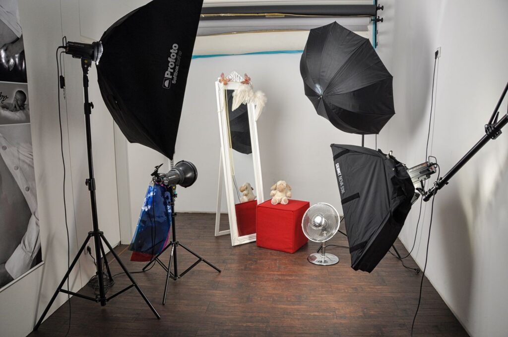 Studio set with softboxes, a mirror and props on a wooden floor
