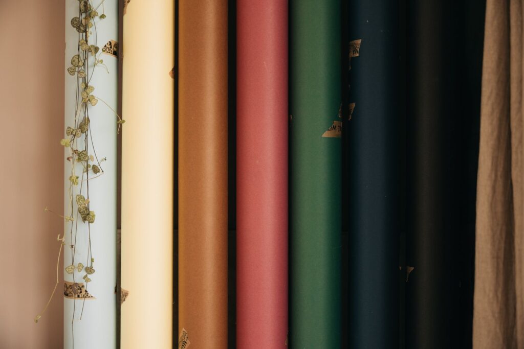 Rolls of coloured backdrop paper standing side by side