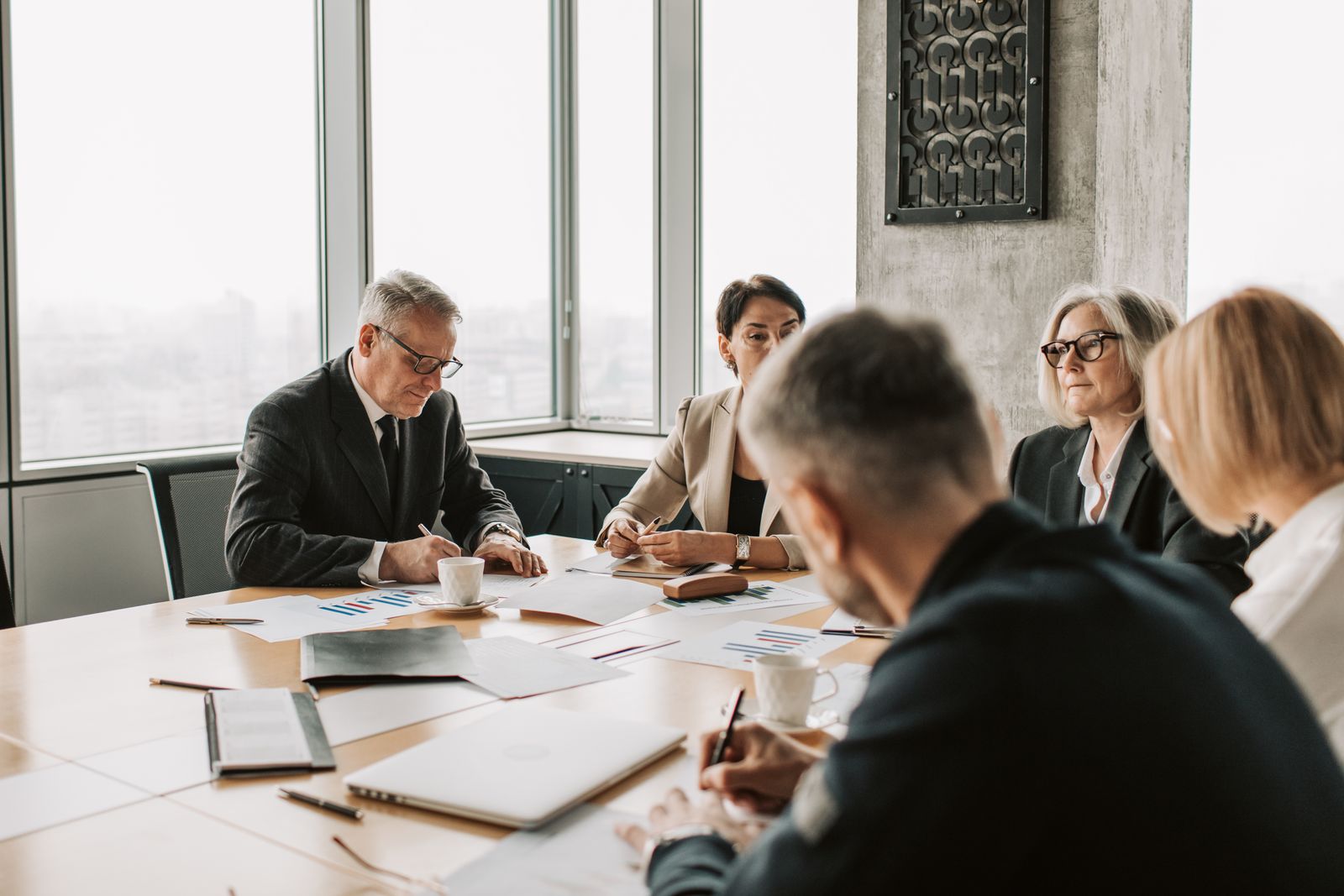 A group of colleagues in discussion around a conference table