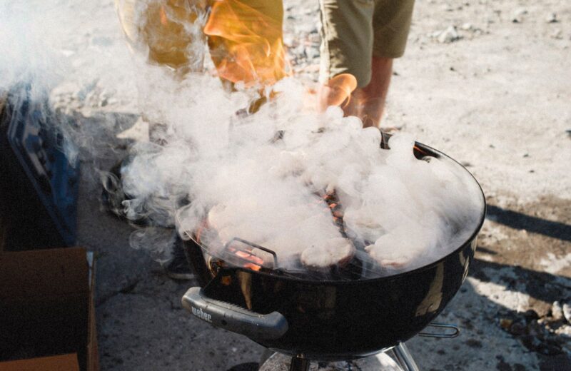 Smoke rising from a barbecue pit outdoors