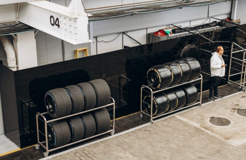 Tires stored on racks along a workshop wall