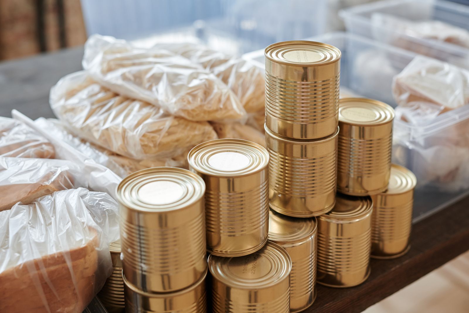 Tins and dry food stacked on a table, ready to pack into parcels