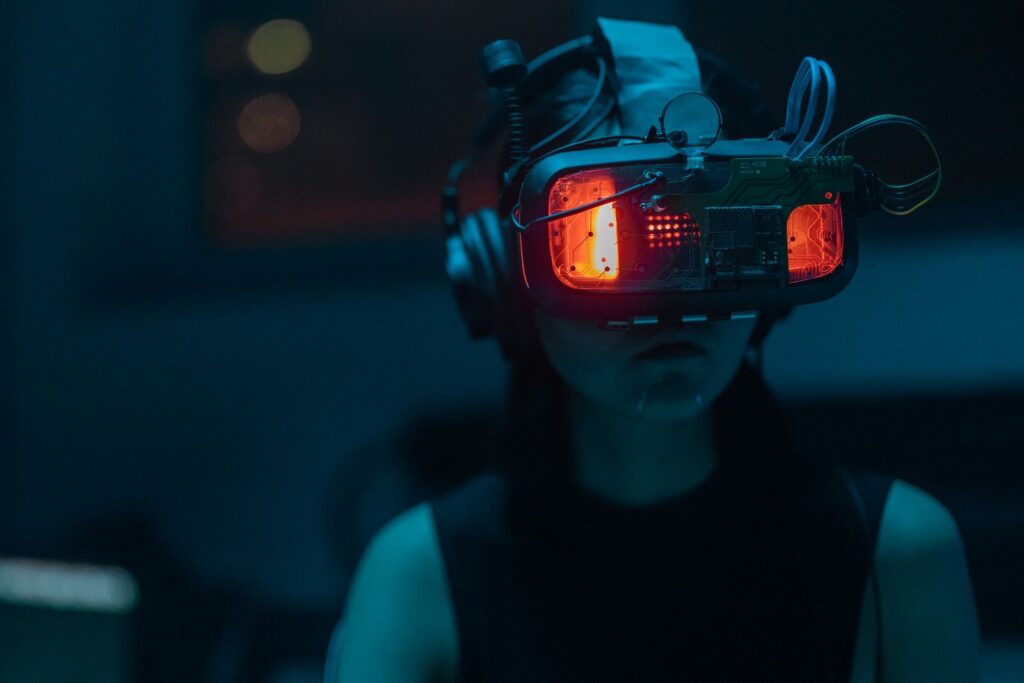 A woman wearing a VR headset in a dim teal-lit room