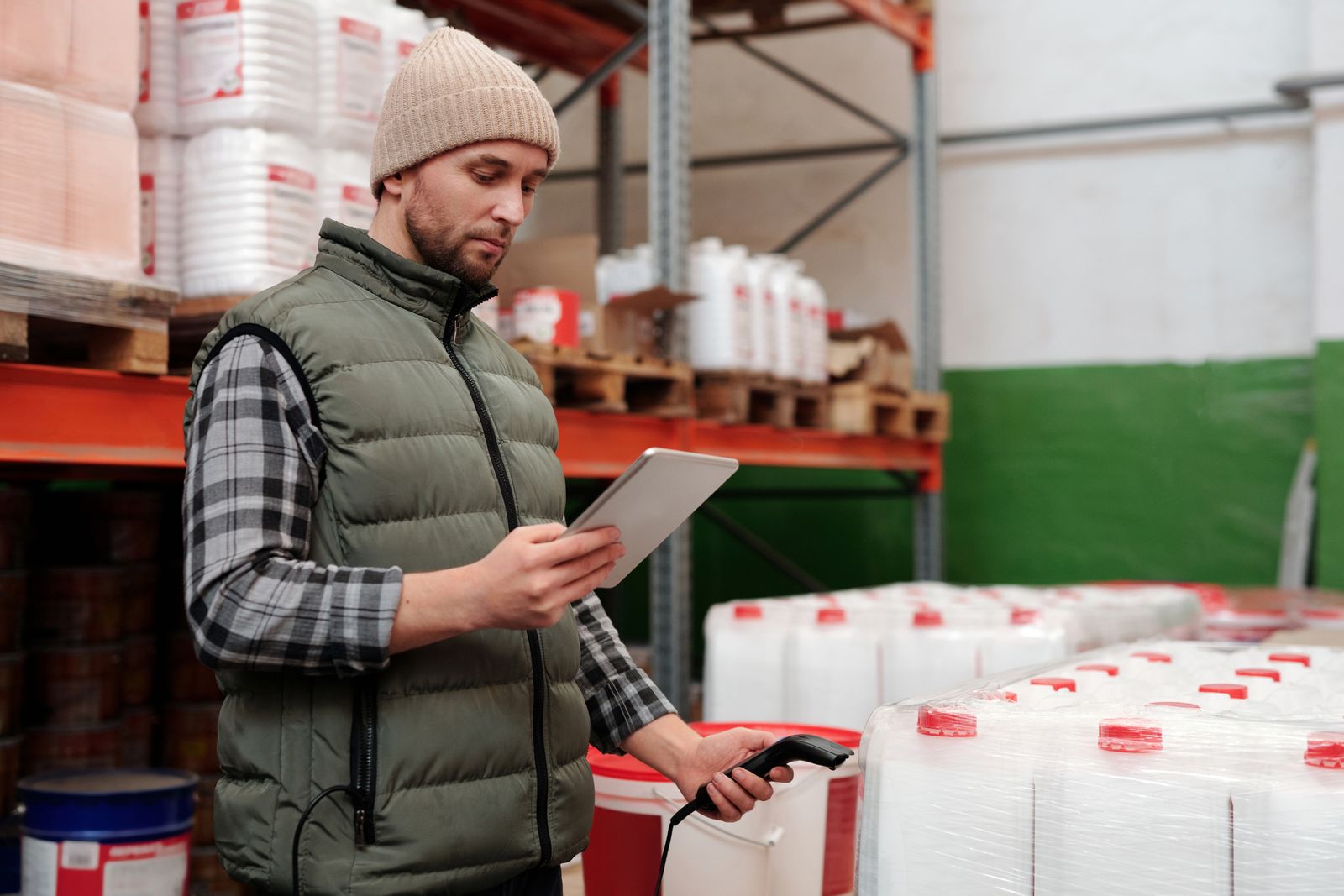 A warehouse worker scanning stock with a handheld scanner