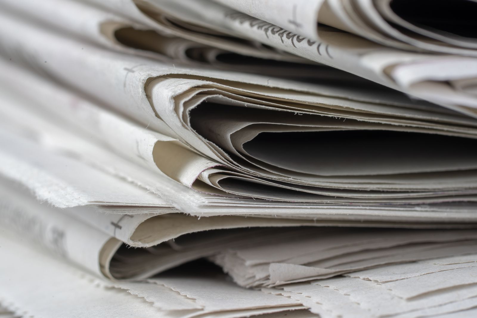 A stack of folded newspapers seen close up