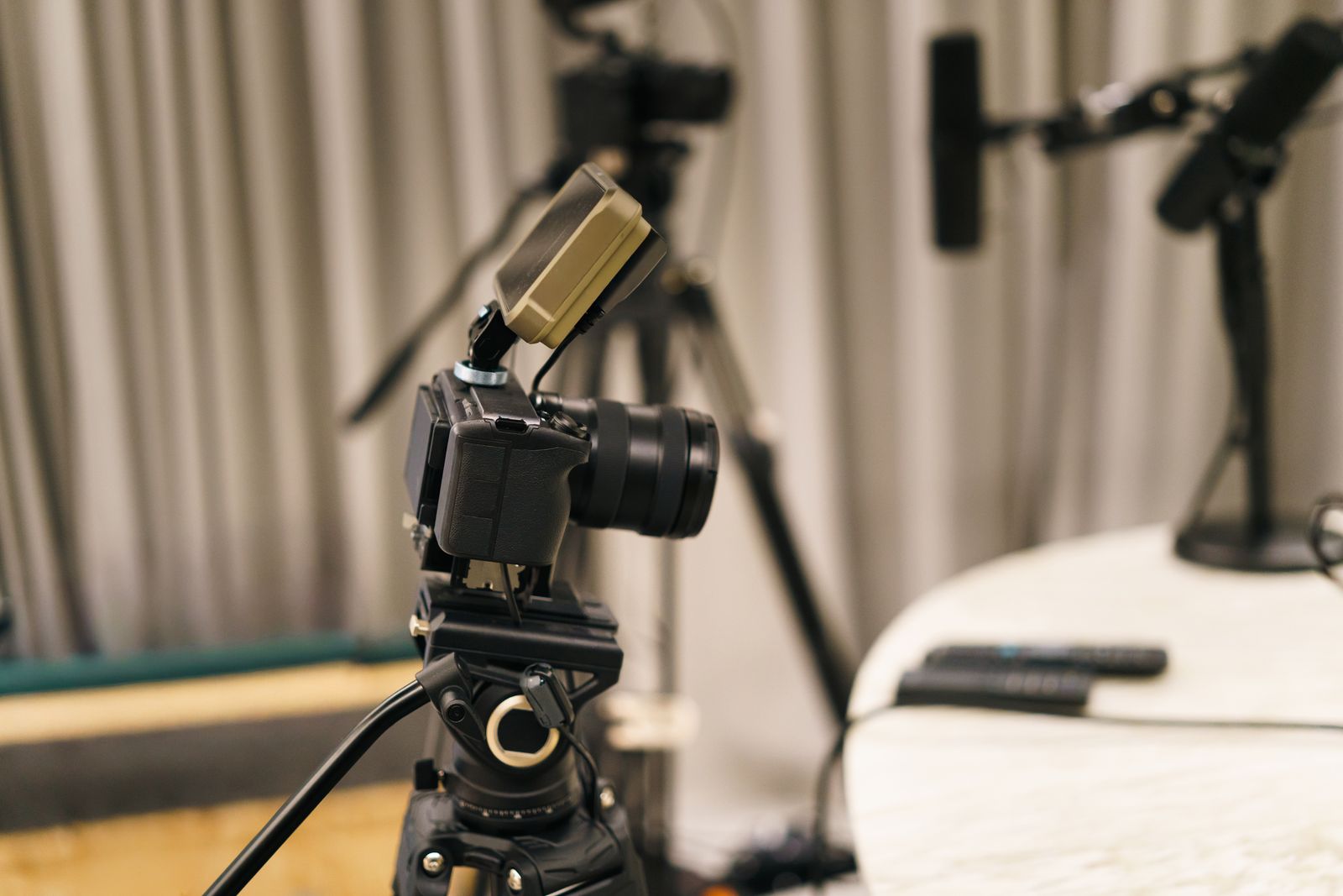 A video camera and a microphone set up for an interview in a studio