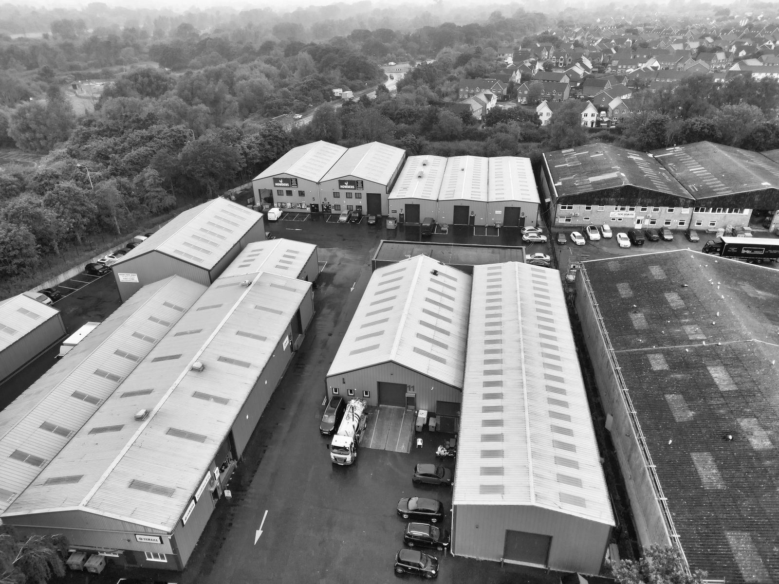 Aerial black and white view of industrial units and yards