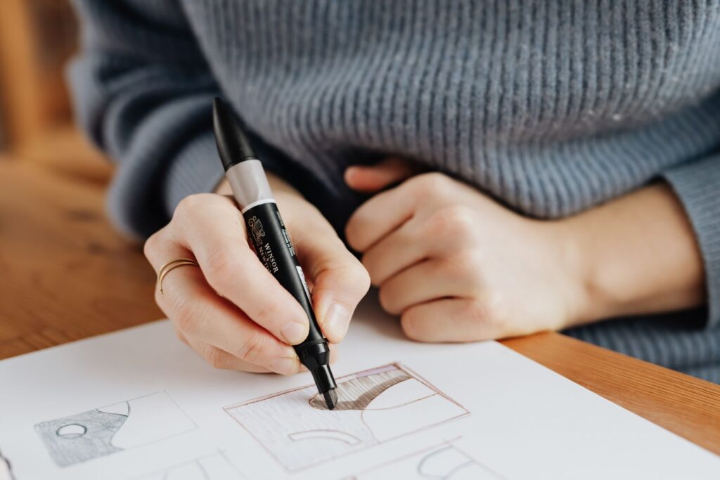 A hand drawing with a brown marker on a large sheet of paper