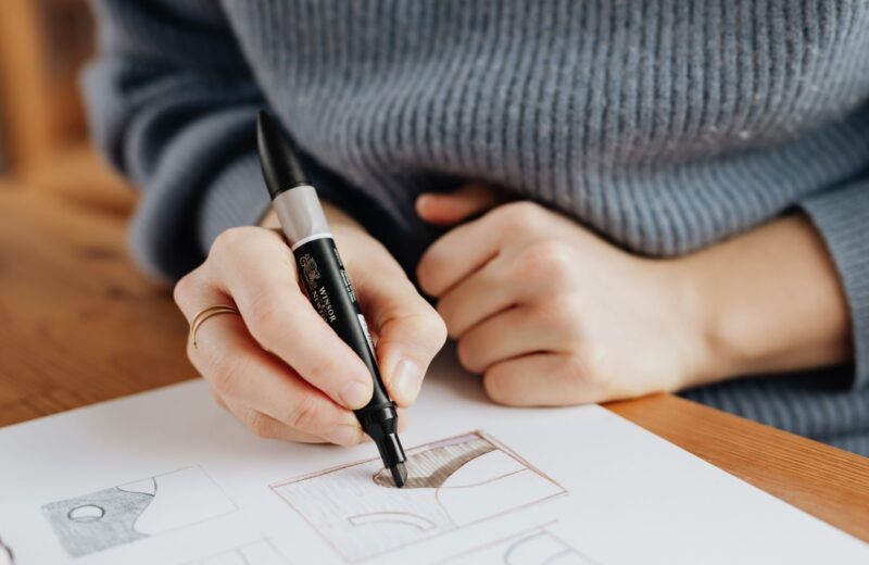 A hand drawing with a brown marker on a large sheet of paper