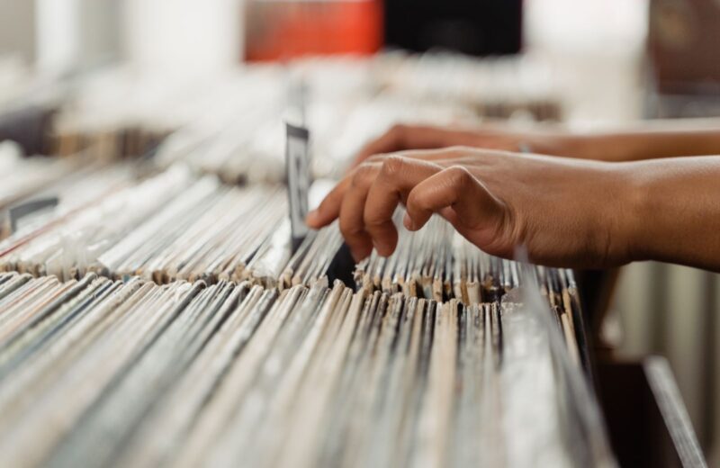 Fingers flicking through records in a crate