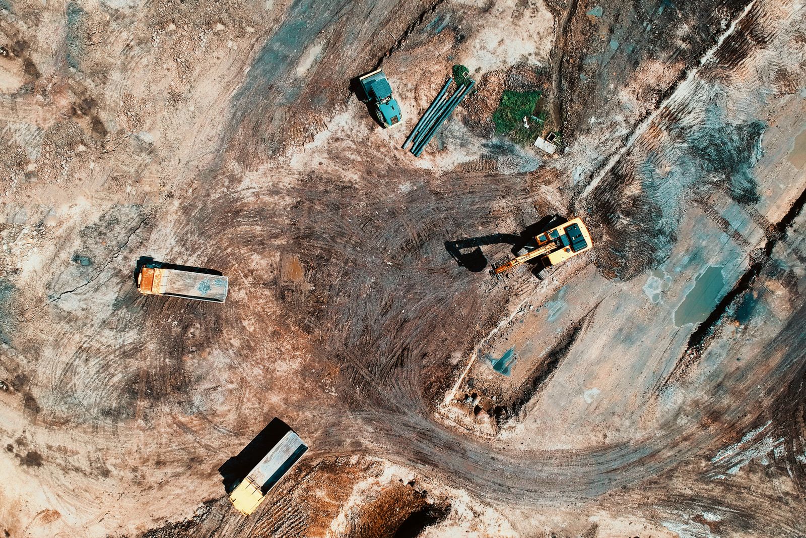 Earthworks on a building site from above, with diggers and trucks