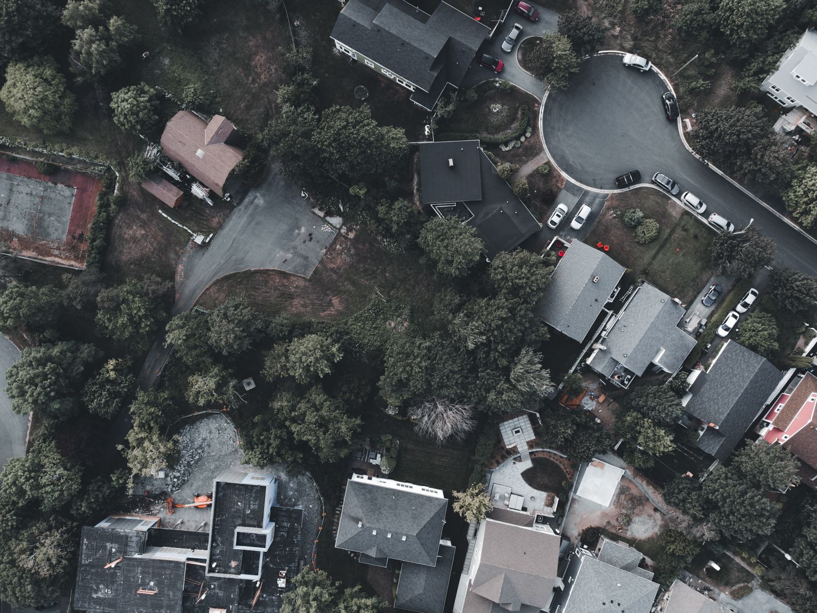 Suburban houses, gardens and streets seen straight down from a drone
