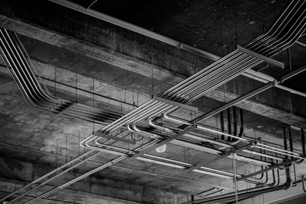 Cable trays and conduit running under a concrete ceiling