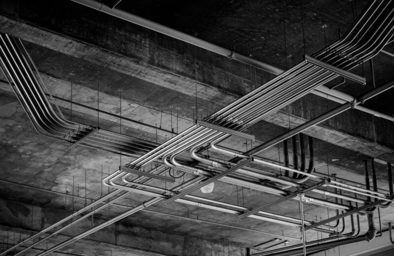 Cable trays and conduit running under a concrete ceiling