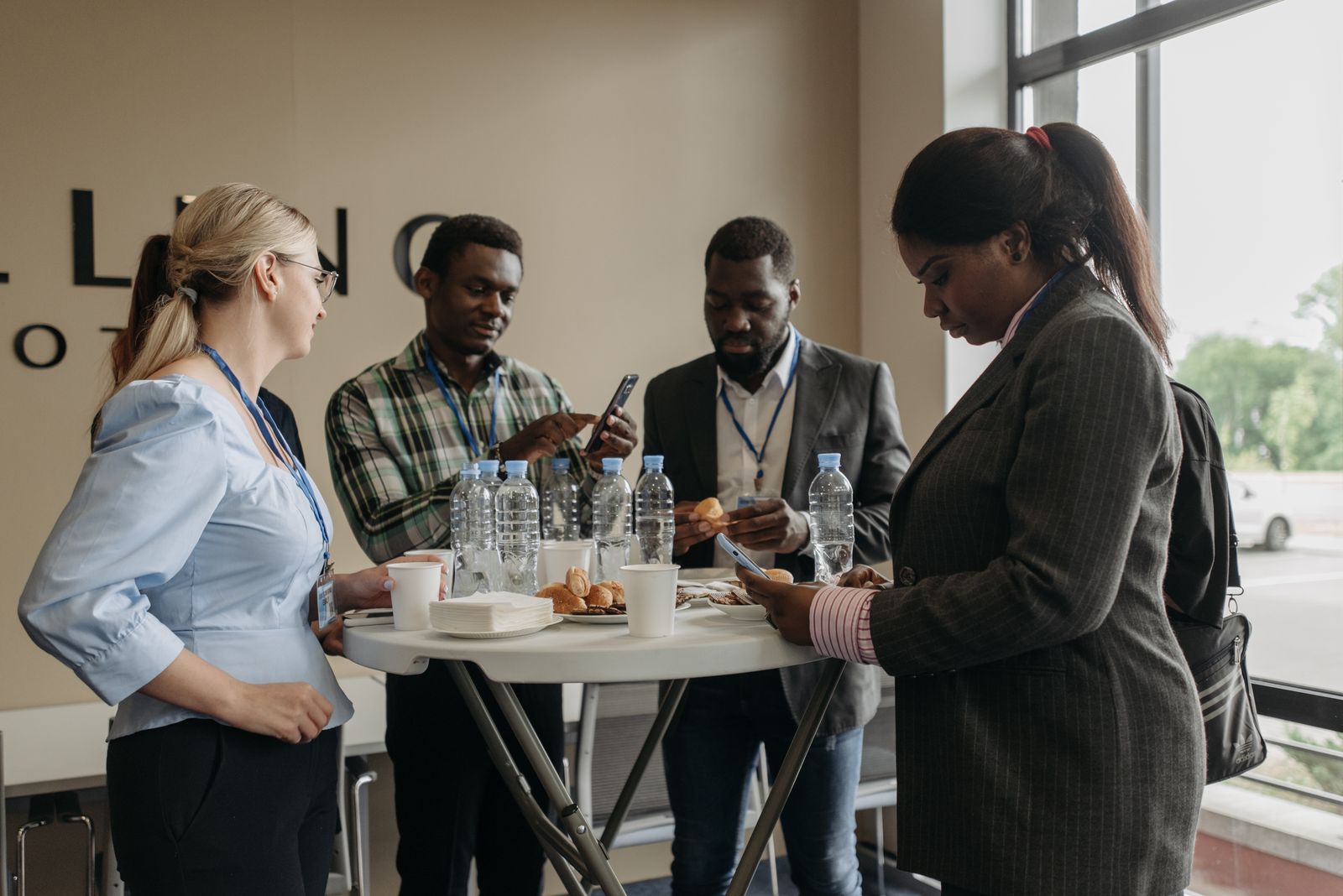 Delegates talking around a high table during a coffee break