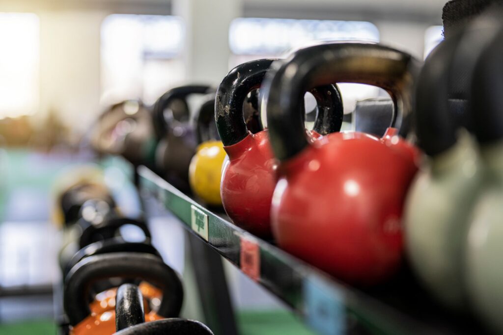 Coloured kettlebells lined up on a rack