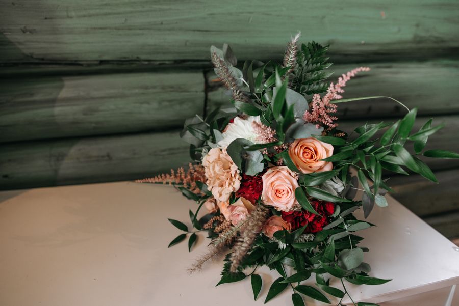 A loose garden bouquet of roses, astilbe and greenery on kraft paper