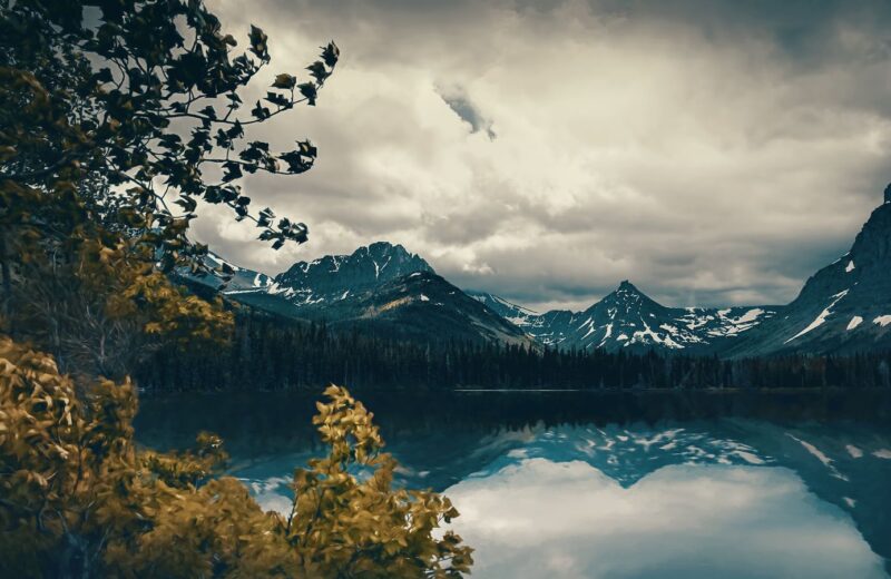 Mountains and dramatic clouds reflected in a still lake