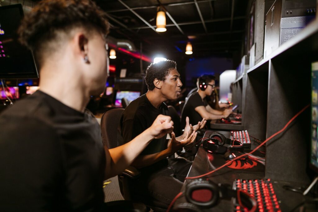 Players with headsets at a row of computers in a gaming venue
