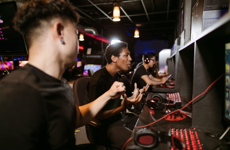Players with headsets at a row of computers in a gaming venue