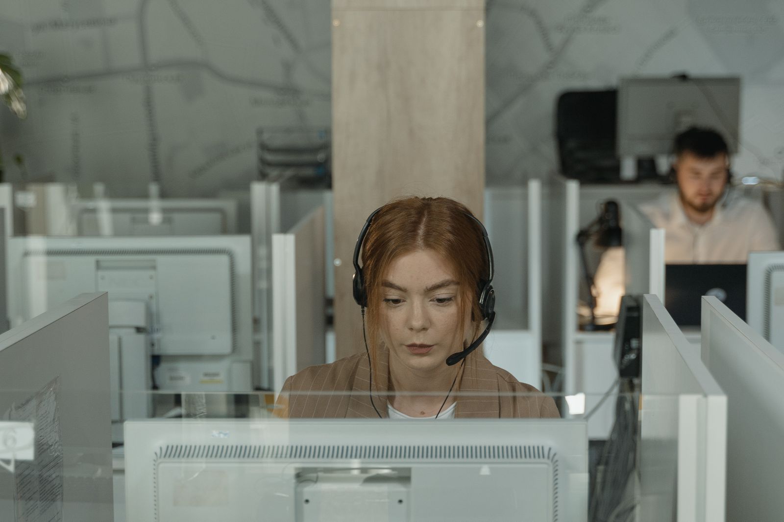 Support team member with a headset working at a desk