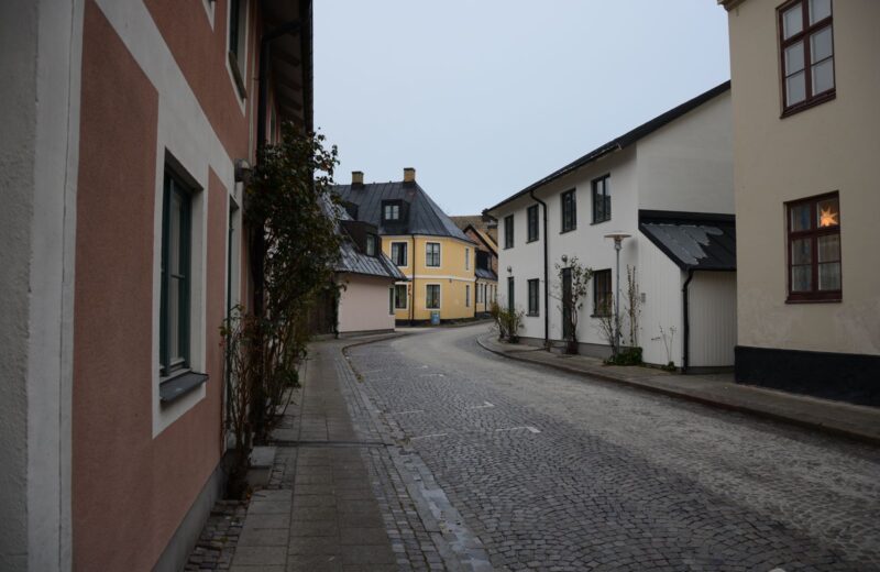 A cobbled street of painted houses in a small town