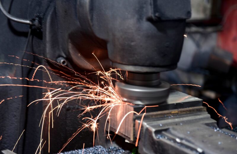 Grinding wheel throwing sparks off a steel part