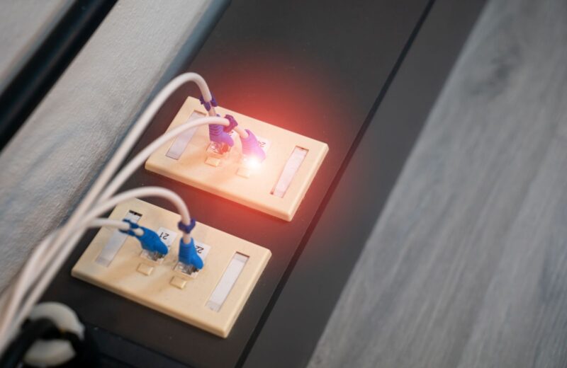 Network cables in a row of ports with a green status light