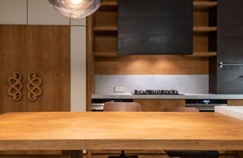 Oak kitchen worktop and cabinets with a stove and simple shelves