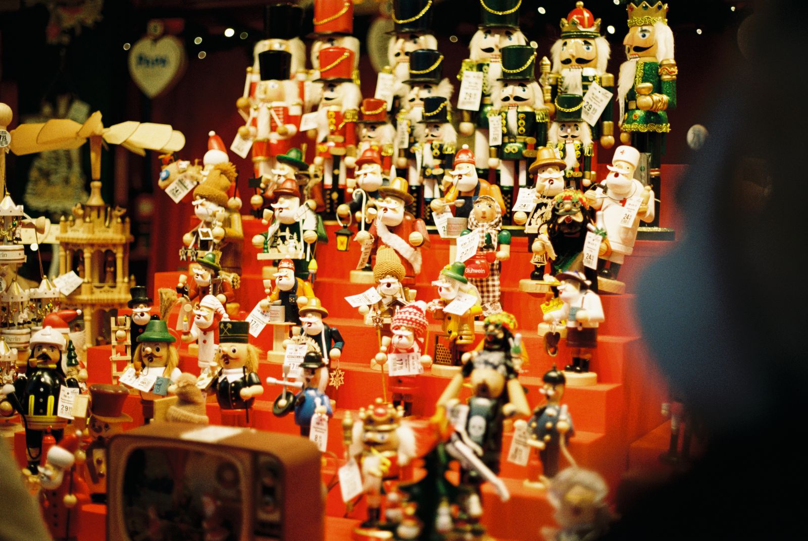 Rows of painted wooden nutcracker figures on a market stall
