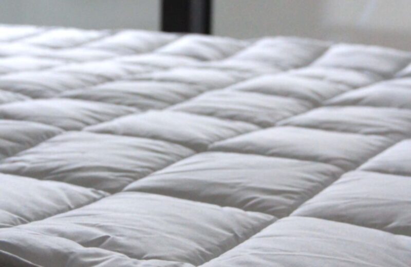Close-up of a white quilted mattress top
