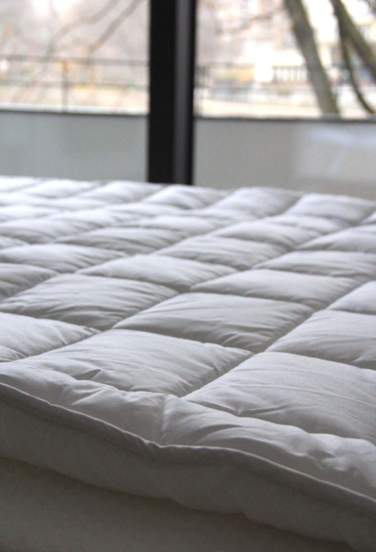 Close-up of a white quilted mattress top