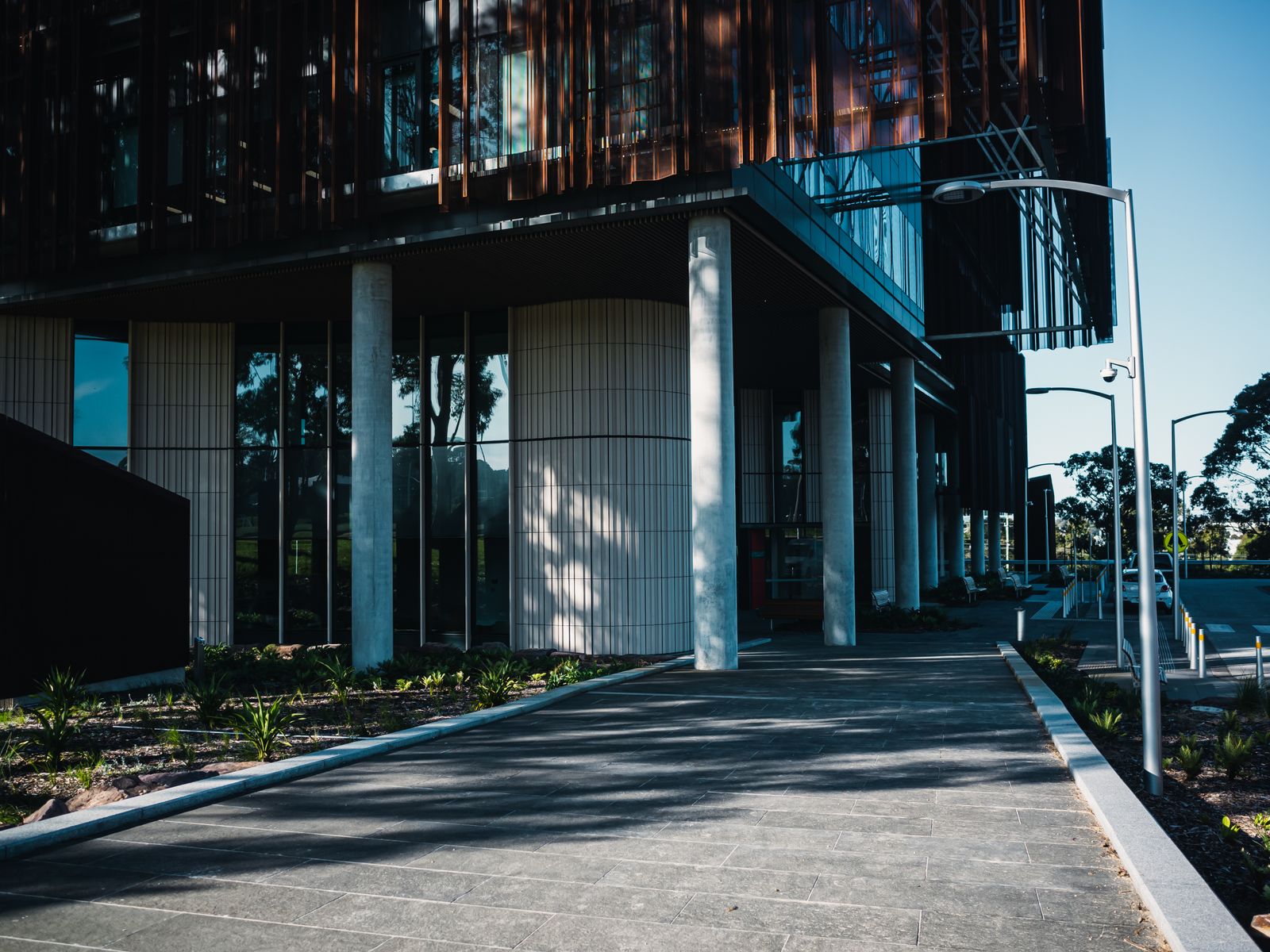 A modern healthcare building with a landscaped path to the entrance