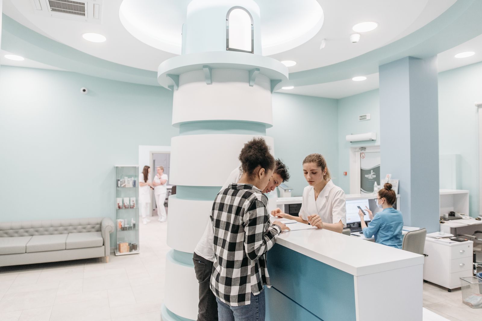 Patients checking in at a clinic reception desk