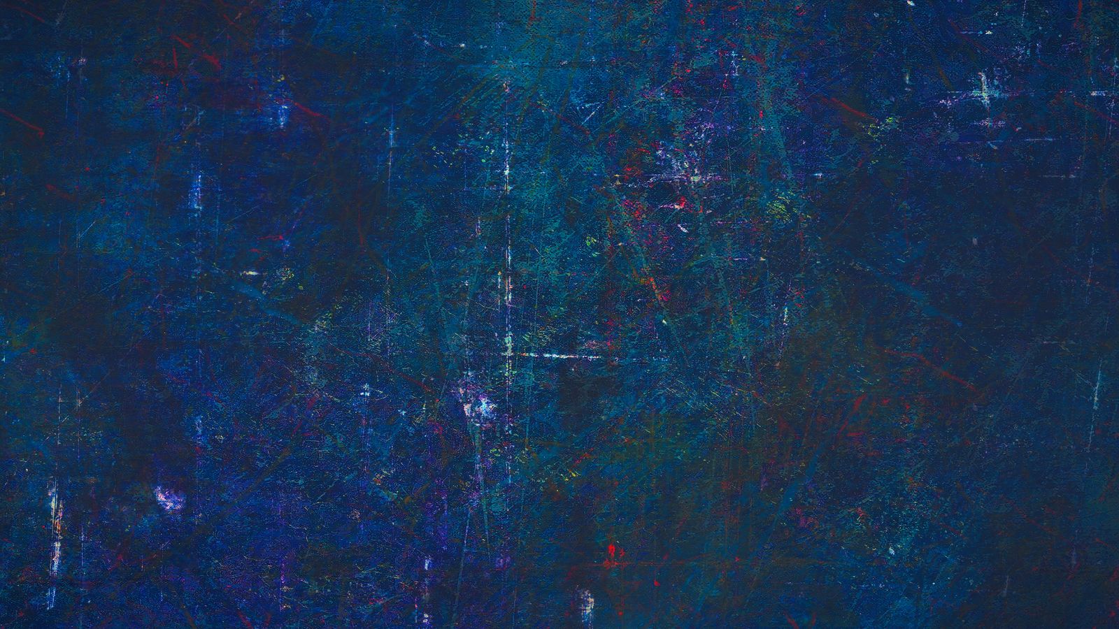 A blue painted wall with scratches and a rough, worn surface