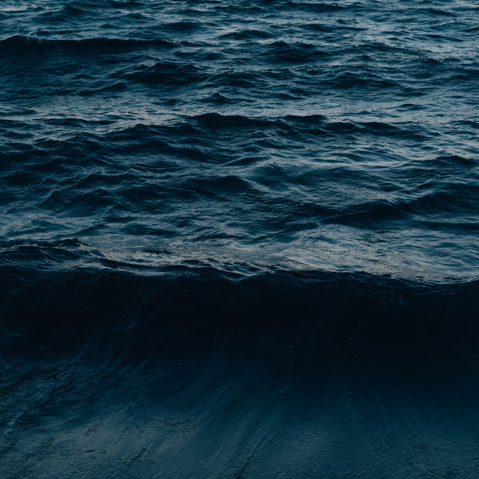 Dark blue-green sea with small waves at dusk