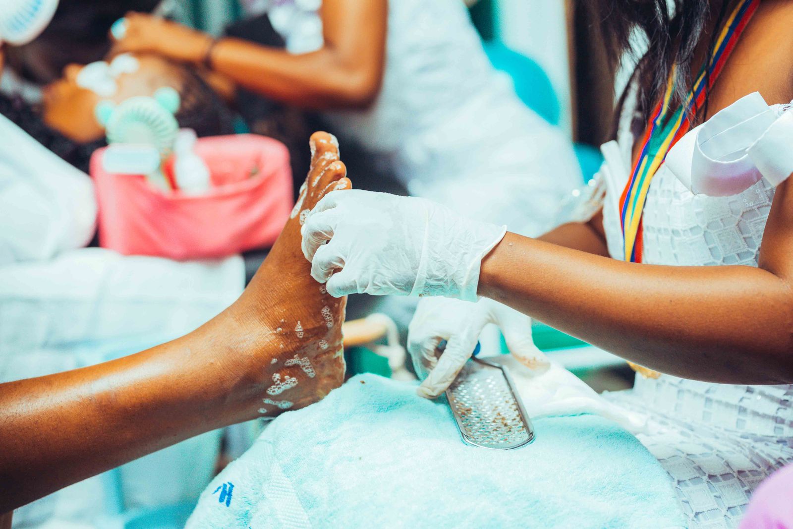 A pedicure in progress, the technician working on a client's foot