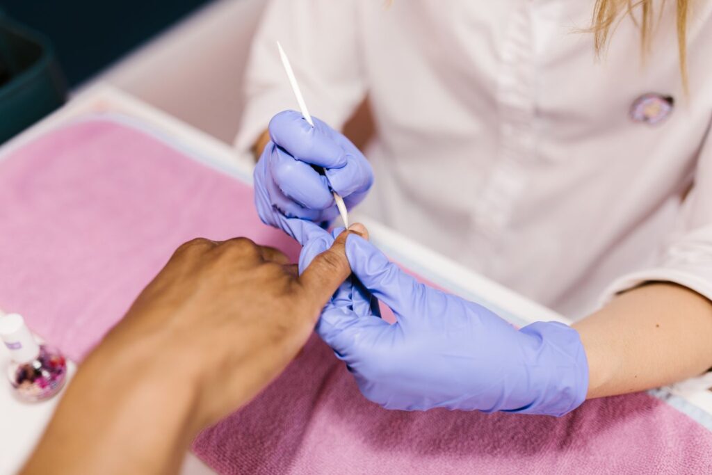 Cuticle care with an orange stick during a manicure