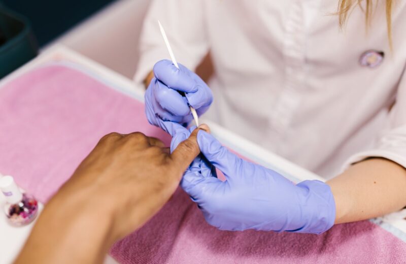Cuticle care with an orange stick during a manicure