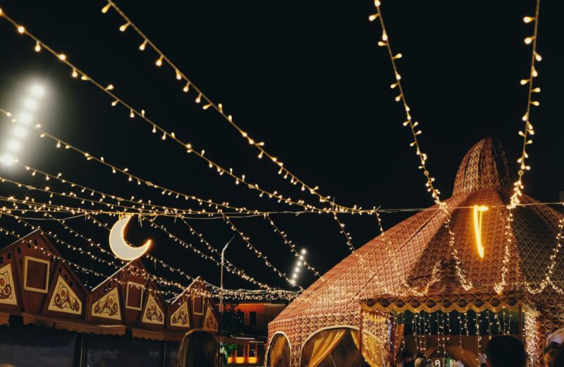 Strings of lights over festival tents at night