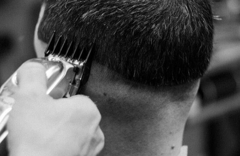 Clippers blending a fade at the back of the head, in black and white