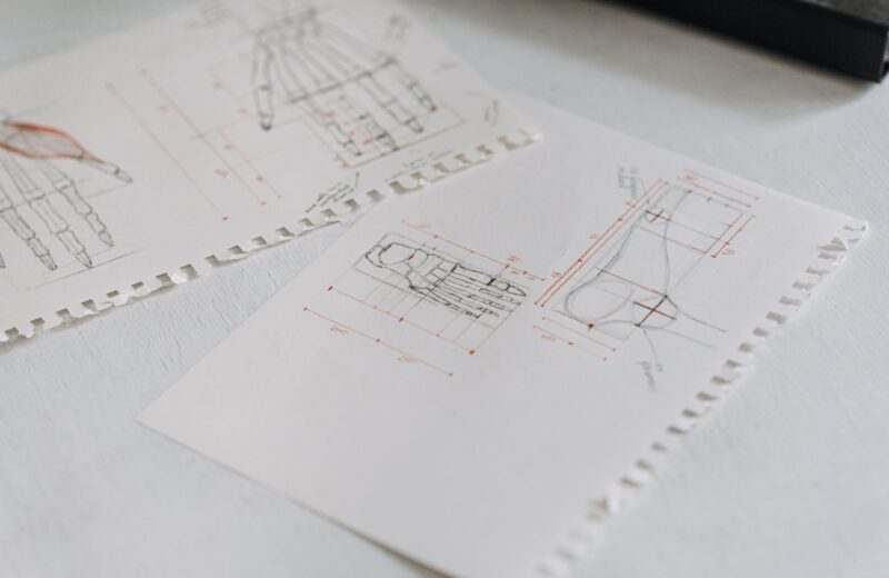 Technical drawings of a product laid out on white paper sheets
