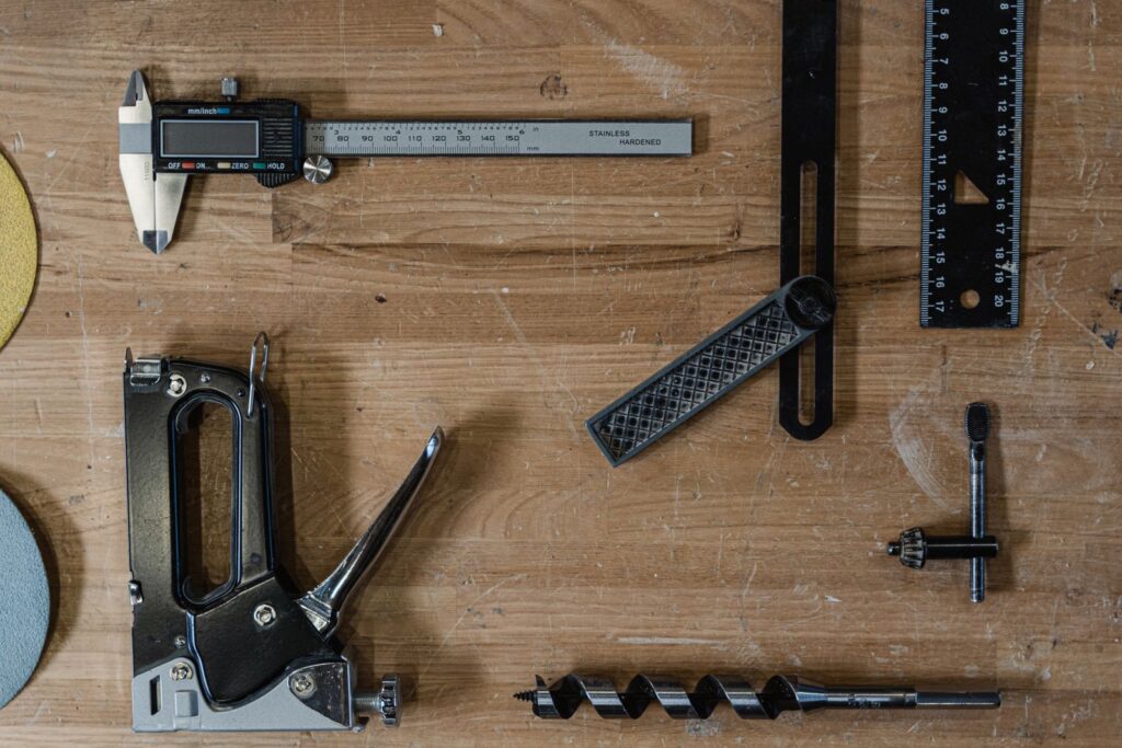 Measuring and woodworking tools laid out on a wooden surface