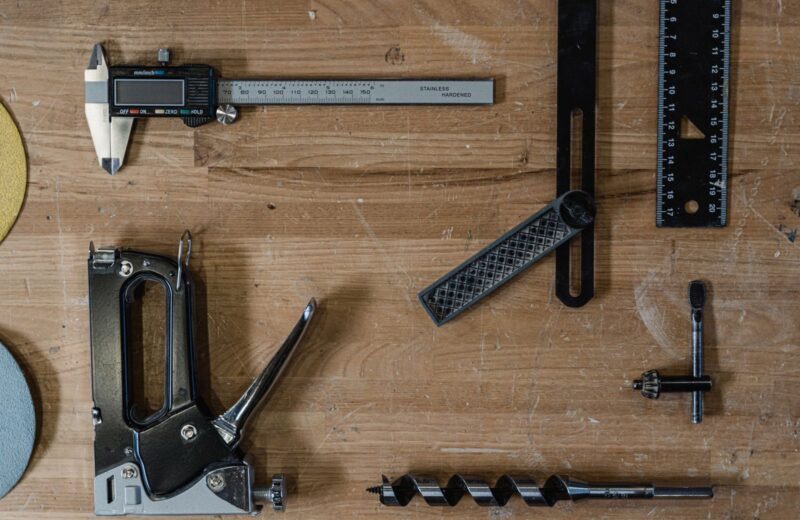 Measuring and woodworking tools laid out on a wooden surface