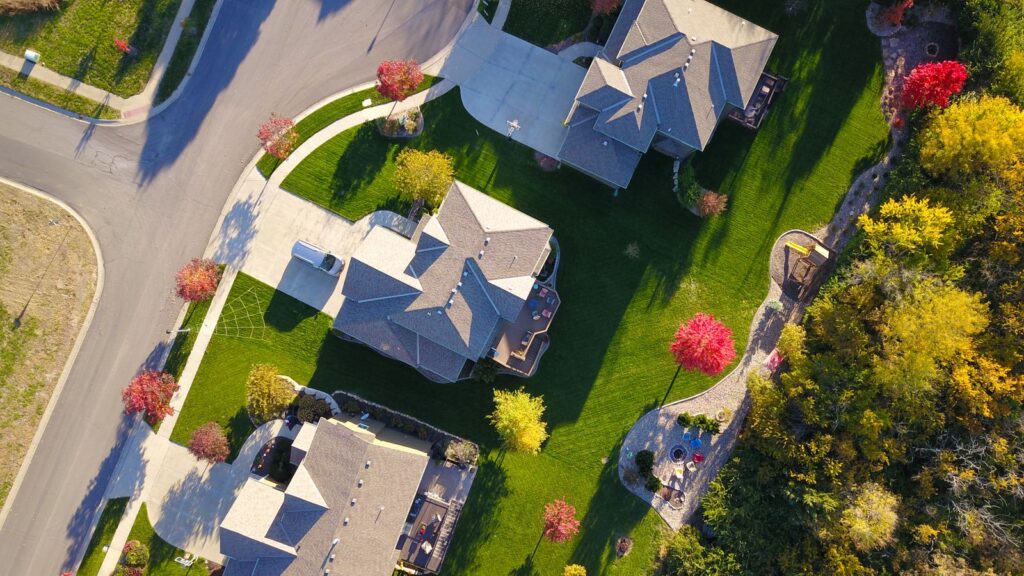 Aerial view of suburban houses, gardens and tree-lined streets