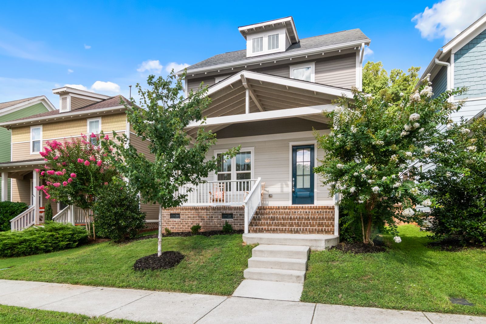 A house with a front lawn and a path to the sidewalk