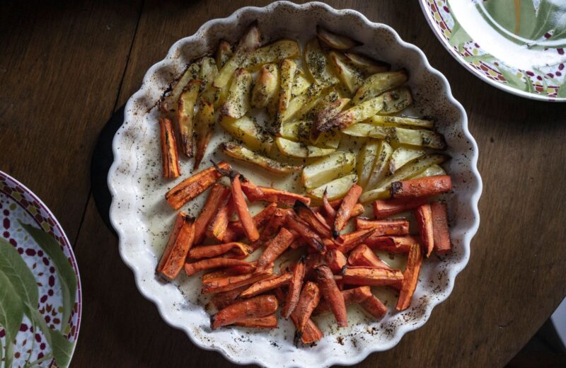 Roast potatoes and carrots with herbs on a plate