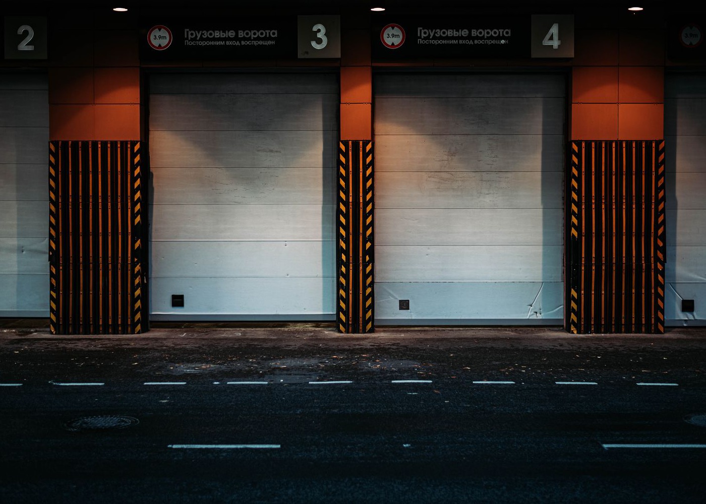 Numbered loading dock doors, closed, at night