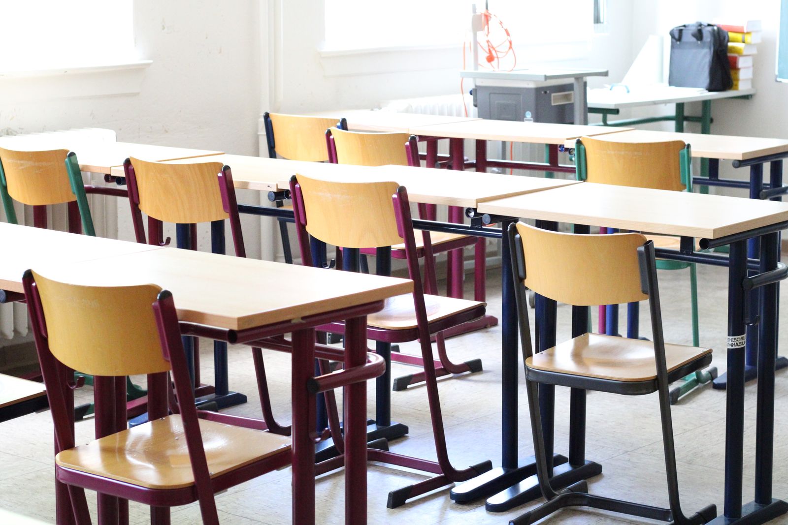 Empty classroom with wooden tables and chairs before the first lesson